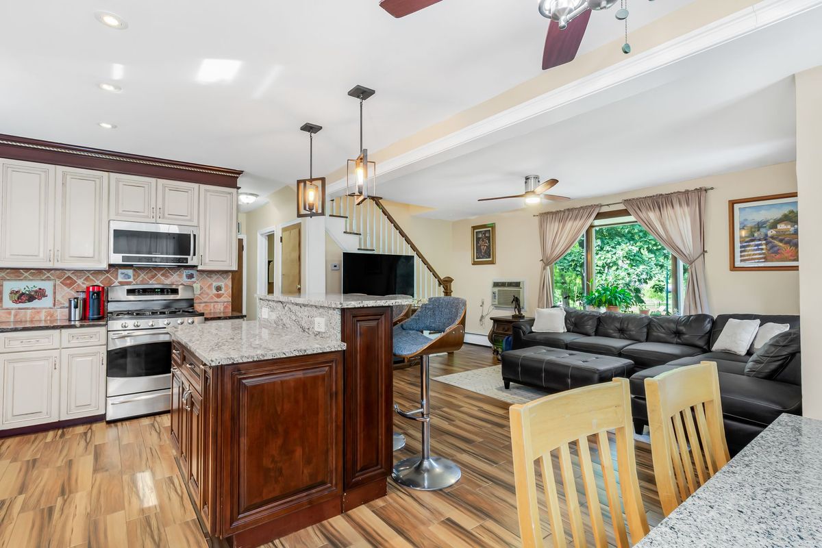 Bright and airy open-concept kitchen and living room with modern decor and natural lighting.