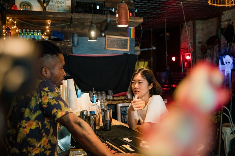 A diverse group socializing at a cozy bar during happy hours, emphasizing leisure and community.